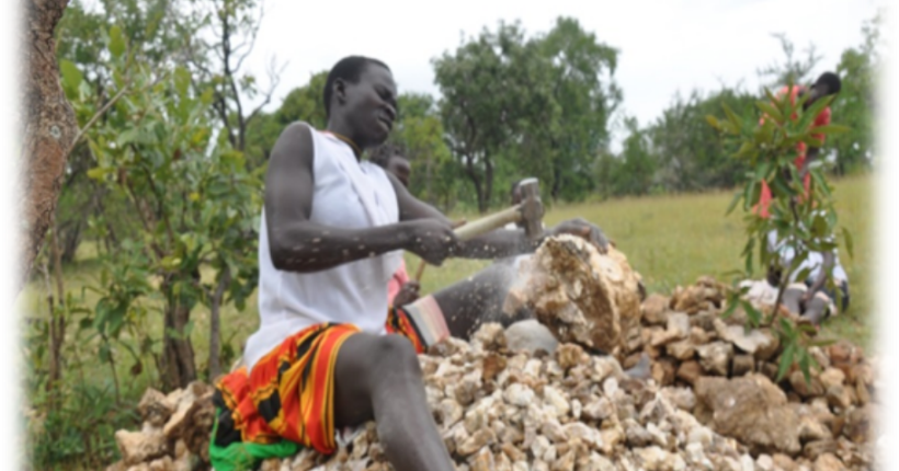 Nachap Agnes crashing stones at the site of a stone quarrying in Motany Ward, Karita Town Council, Amudat District. Photo Credit: Karamoja Women Umbrella Organization