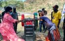 Moroto Resident District Commissioner, Jane Francis Okili Amongin hands over a stone quarrying machine to a group of women at one of the communities in Moroto. Photo Credit: RIAMIRIAM CSO Network
